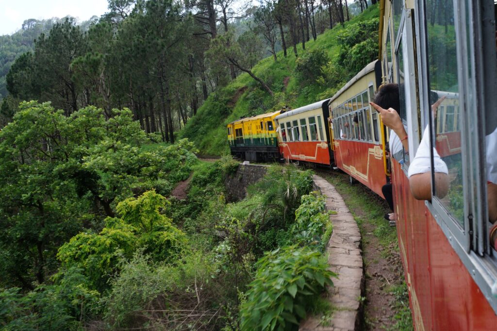 🏞️ Shimla Me Ghumne Ki Best Jagah (Shimla Tourist Places) Kalka Shimla Toy Train passing through green hills, pine forests, and historic railway tunnels